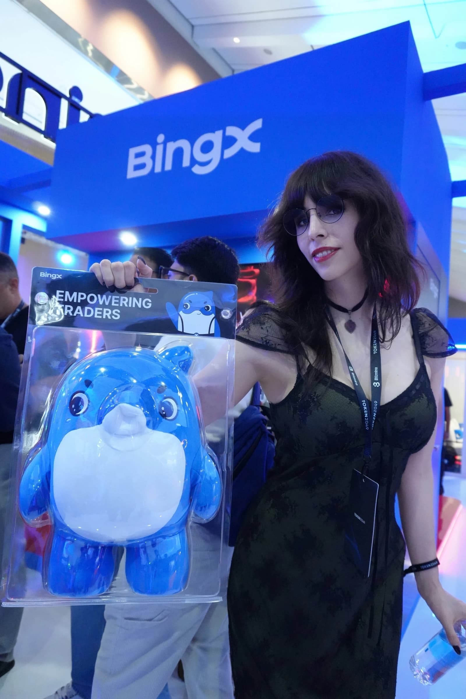 EMINATR1X at a BingX event holding a blue mascot with BingX branding visible