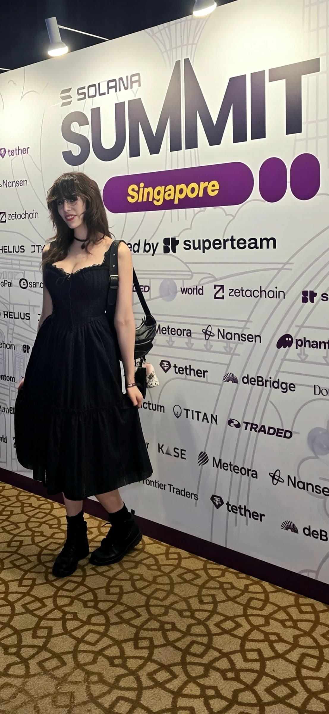 EMINATR1X at Solana Summit Singapore with the event and sponsor wall visible